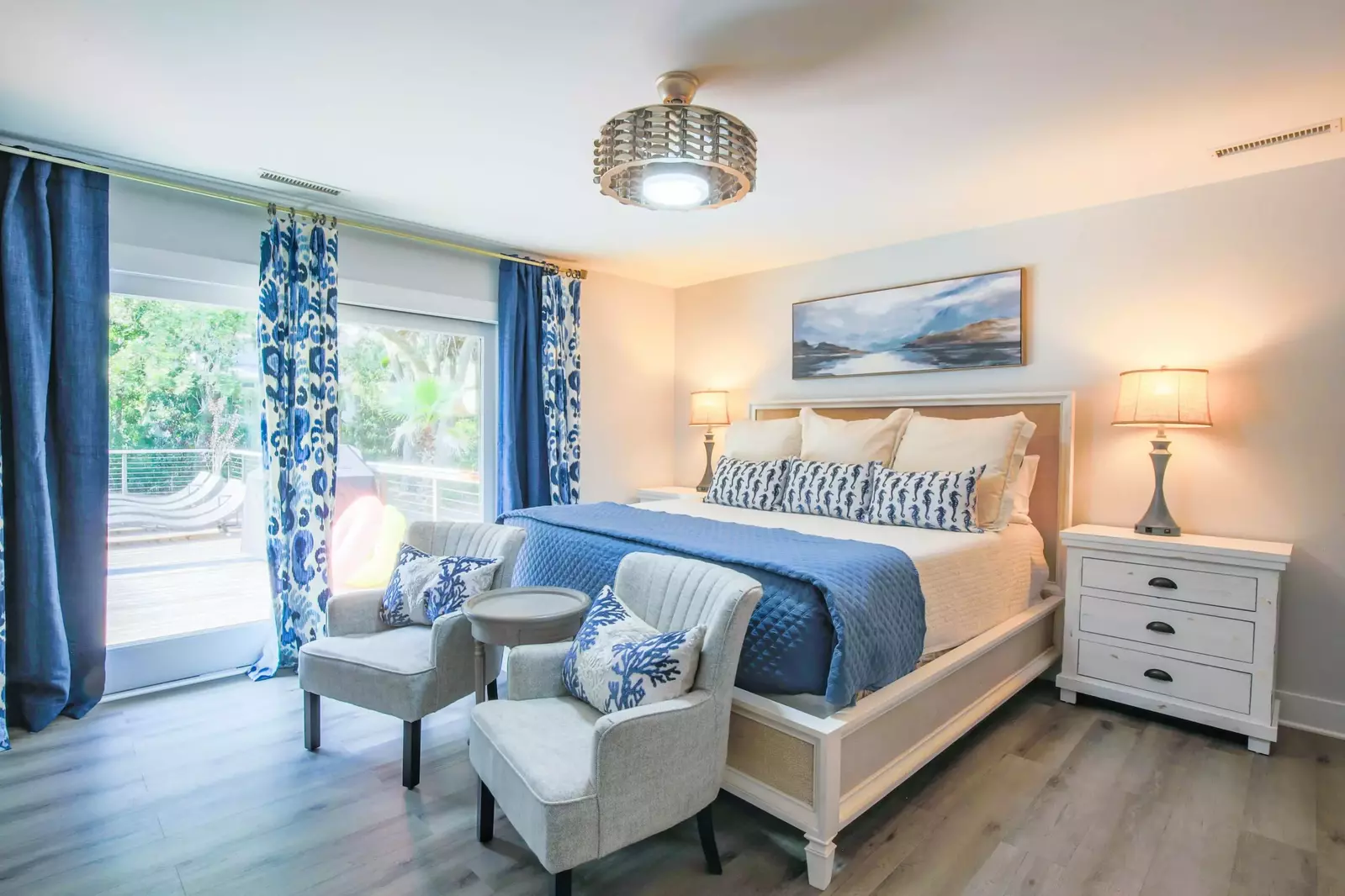 The home's second master suite has sliding door access to the back sun deck & pool area.