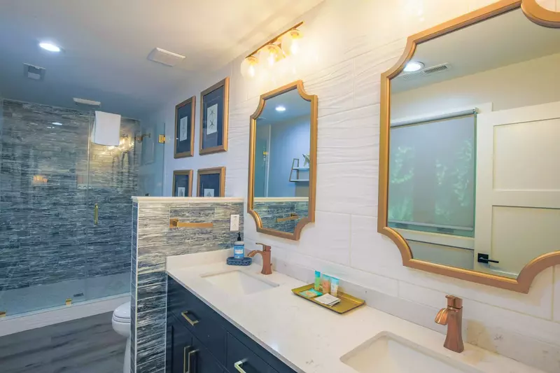 The en suite bath for the second master bedroom features a spacious, double sink vanity.
