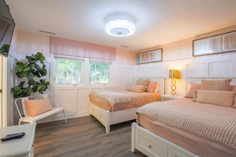 This guest bedroom also has a mounted smart TV and an en suite bathroom.