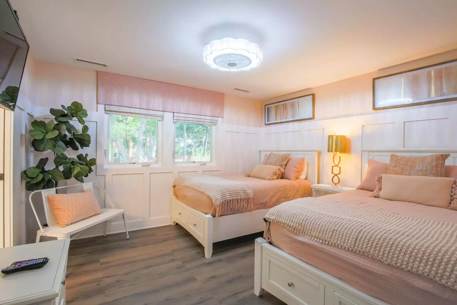 This guest bedroom also has a mounted smart TV and an en suite bathroom.