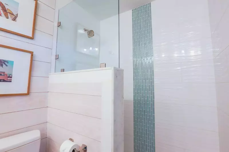 This en suite bathroom has a beautifully tiled, walk-in shower.
