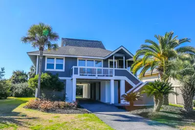 Beachside Cottage is an elevated home with a carport beneath the house.