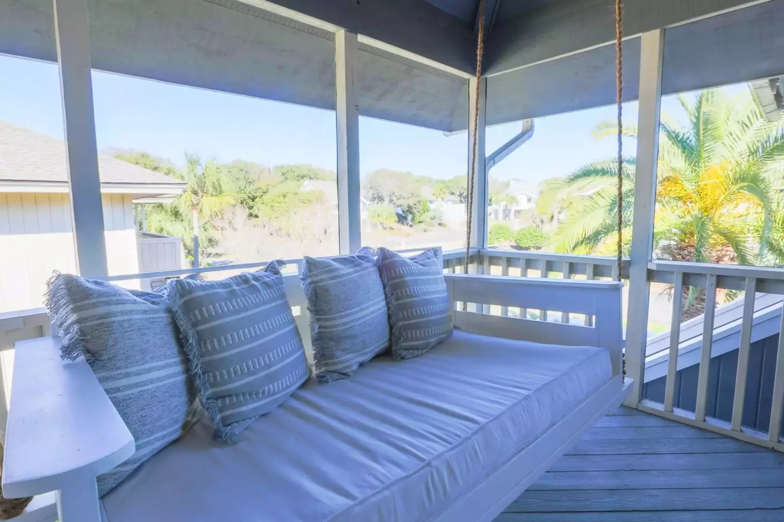 This Charleston bedswing on the screened porch is the perfect spot to start your morning with a cup of coffee.