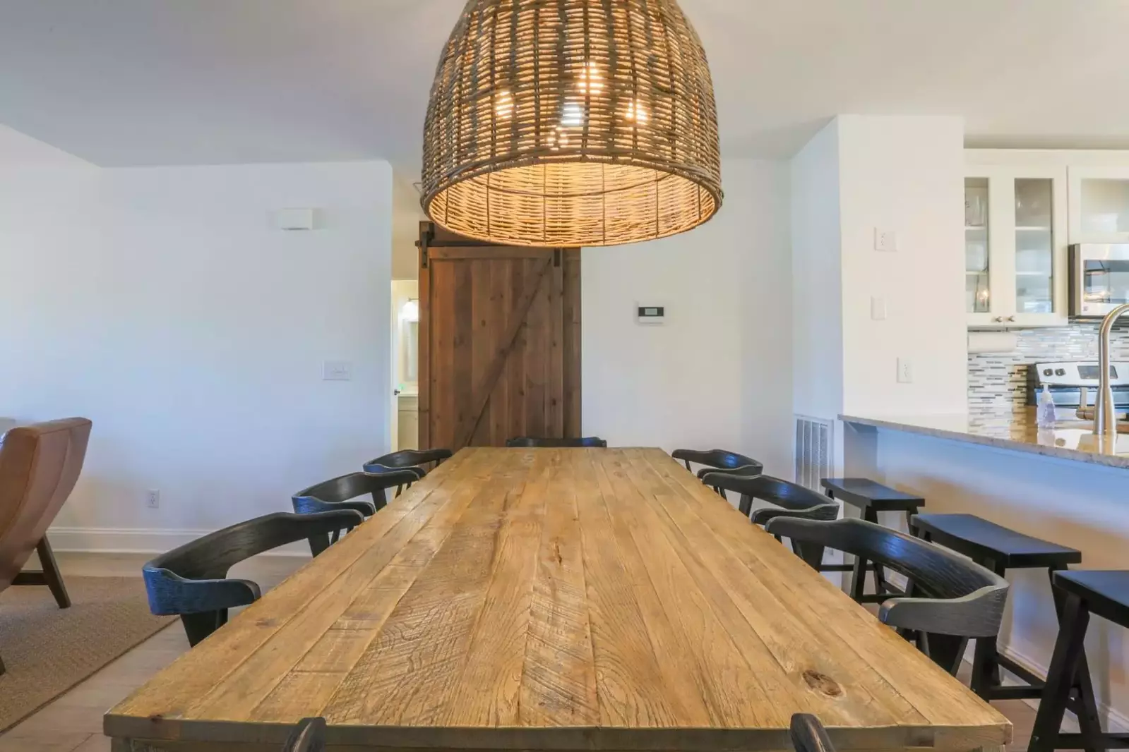 The dining table comfortably seats 8 people.  There are also a total of 5 stools in the kitchen area.