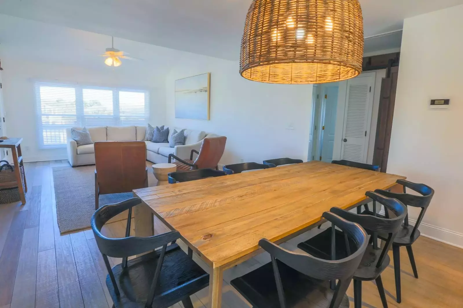 Beachside Cottage features a casual coastal vibe with its wood flooring & comfortable furnishings.