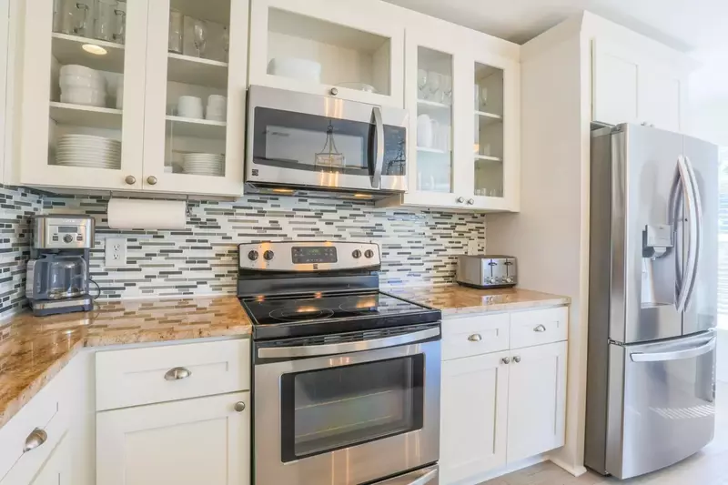 The kitchen has a refrigerator, range, microwave, drip coffee maker, toaster and keurig coffee maker.