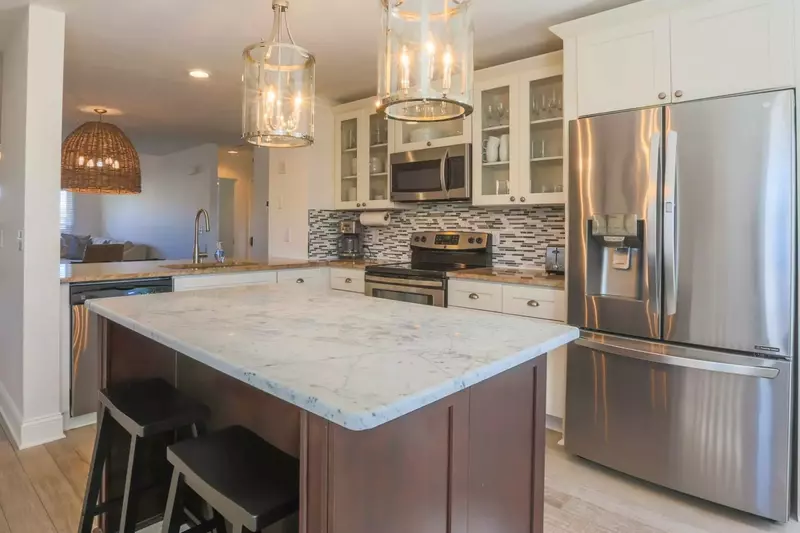 The center island provides the perfect spot to prepare your meals or converse with your family or friends.