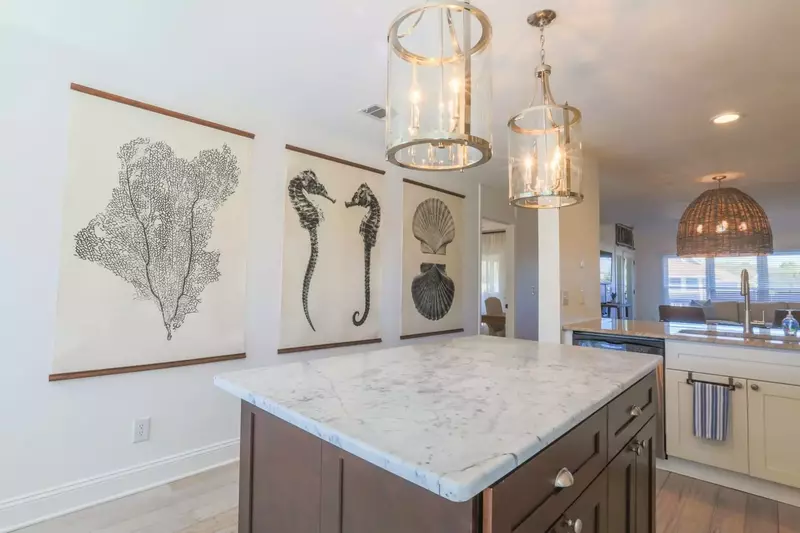 We're swooning over the large coastal-themed art pieces in the kitchen.