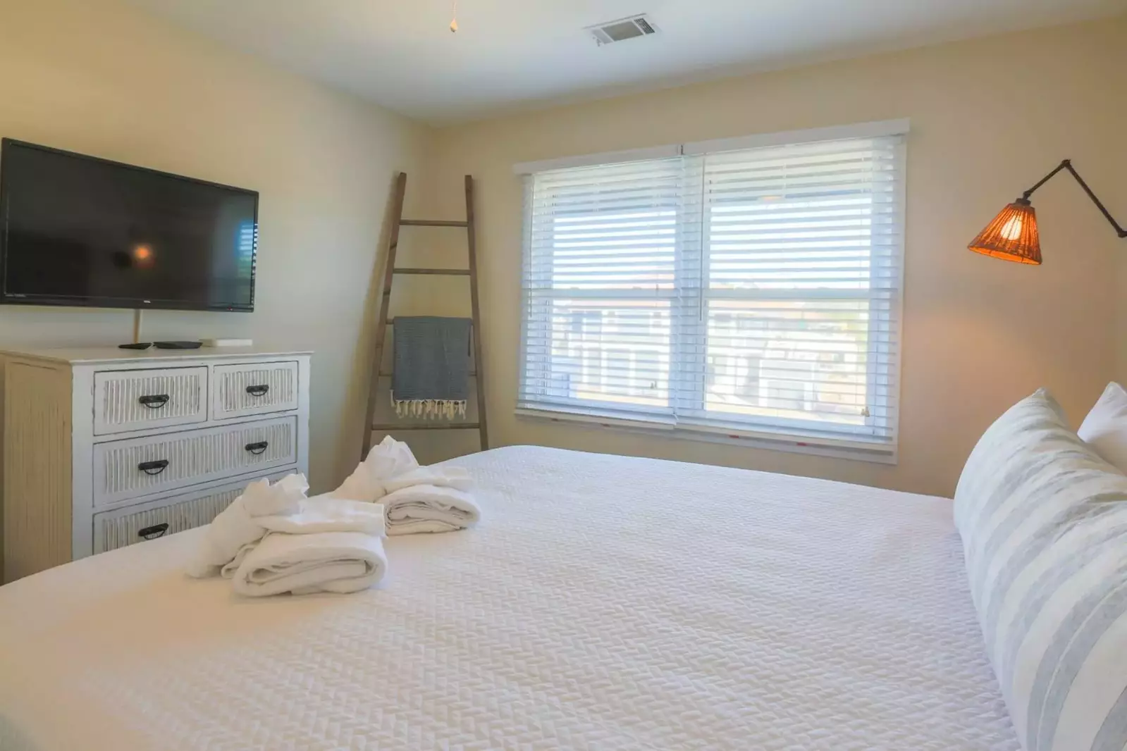 This guest bedroom also has a wall mounted TV with TiVO, which provides access to several streaming channels.