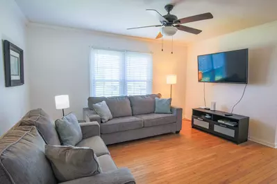 There is a wall-mounted smart TV in the living room.