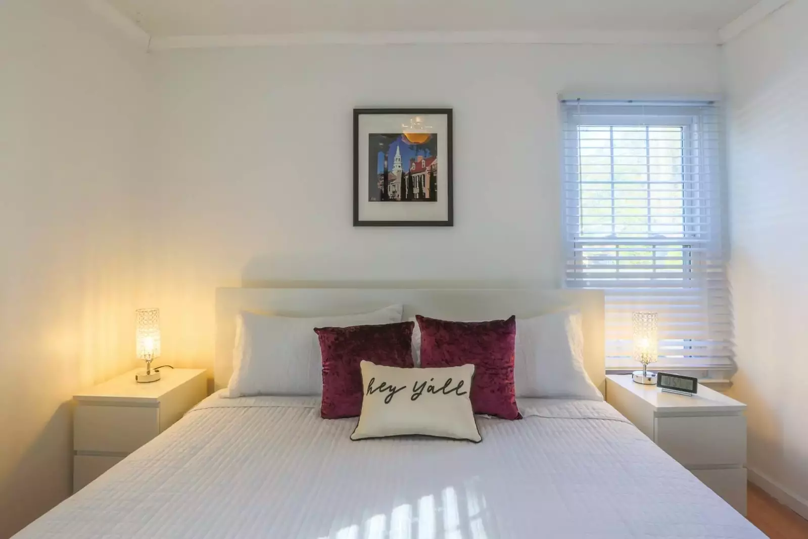 The master bedroom features a king bed and night stands with reading lamps.