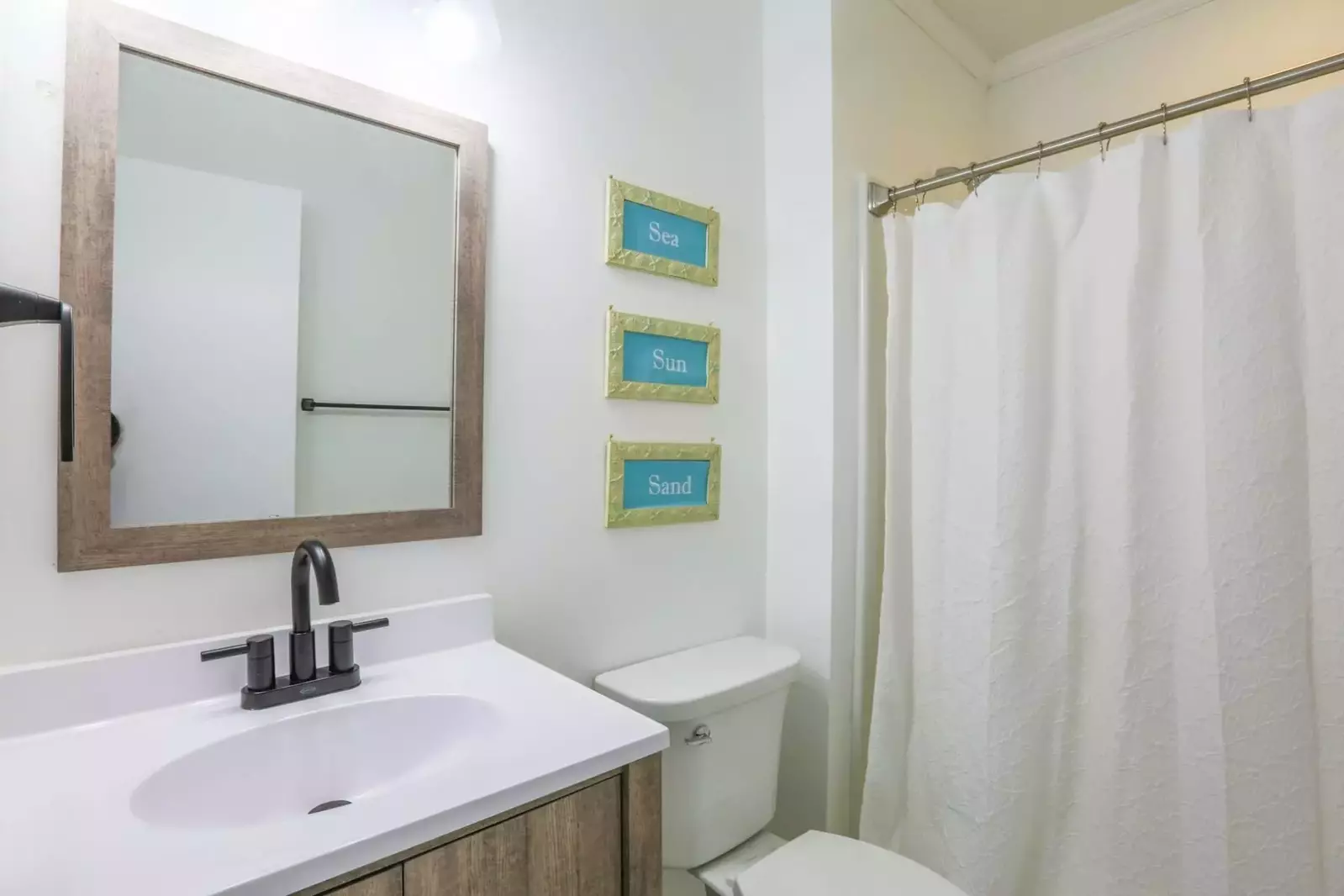 The en suite bathroom has a new vanity and a shower/tub combo.