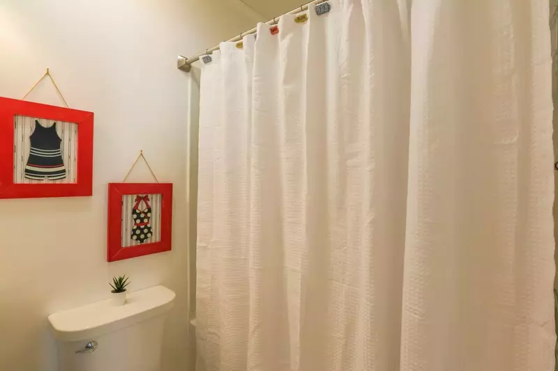 This renovated bathroom has a shower/tub combo.