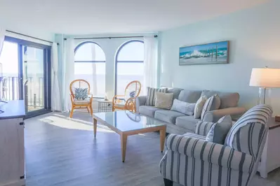 Salty Sunrise features stunning views of the ocean, beach & sand dunes.