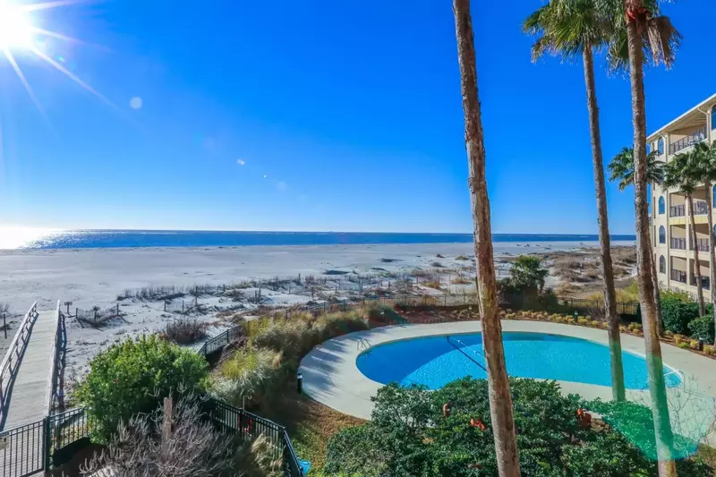 Beautiful grasses, palmetto trees and sand dunes surround the community pool and patio.