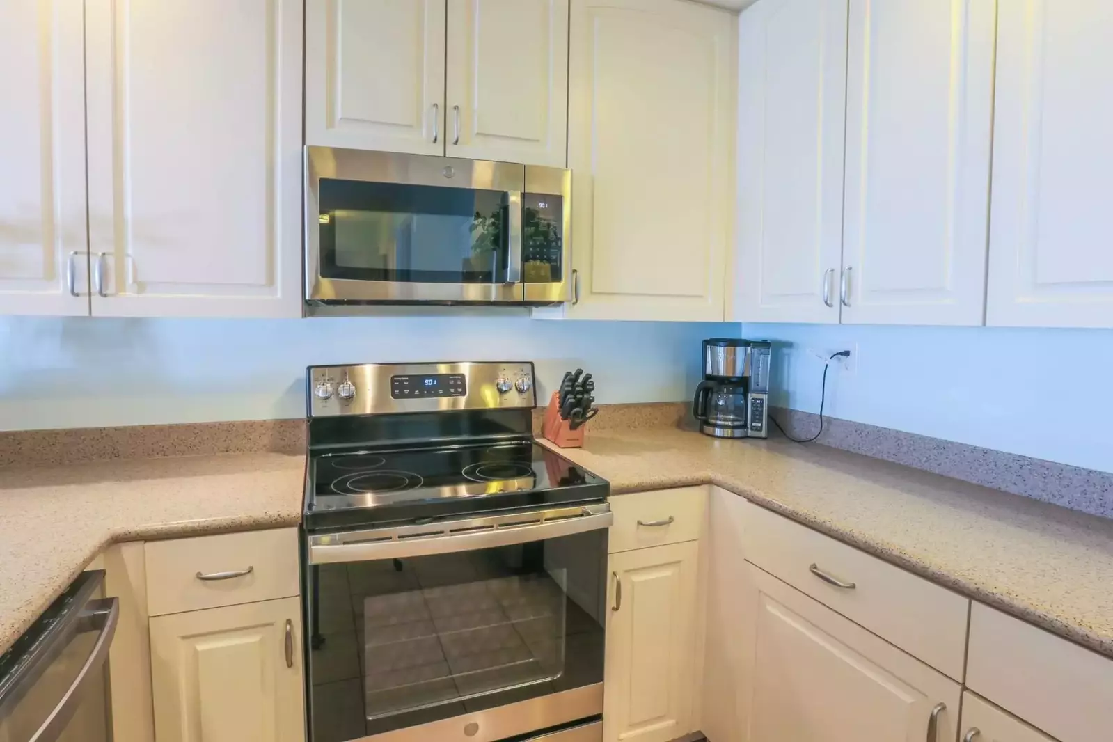 The kitchen is well stocked with new, stainless steel appliances.