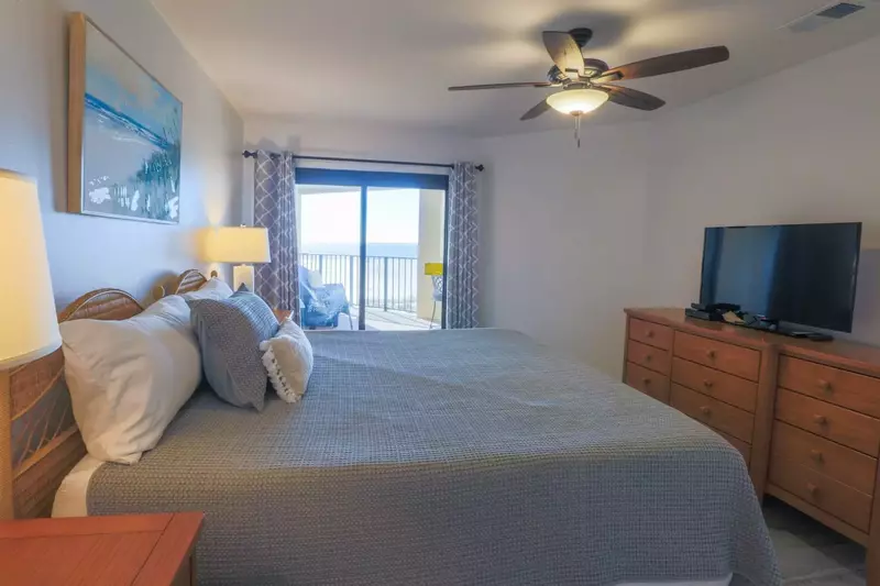 The master bedroom features ocean views, sliding door access to the private balcony and a cable TV.