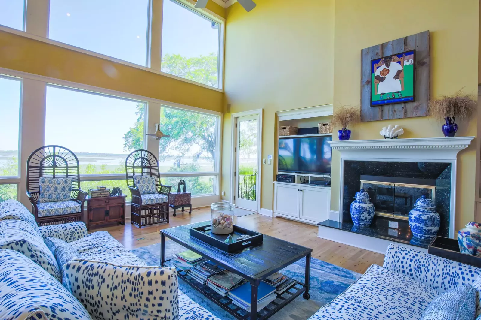 The two story Great Room boasts serene views of the marsh and Kiawah River.