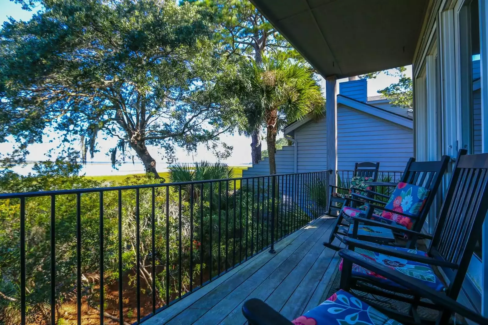 Palmetto trees, live oaks with Spanish moss and pine trees surround the home.
