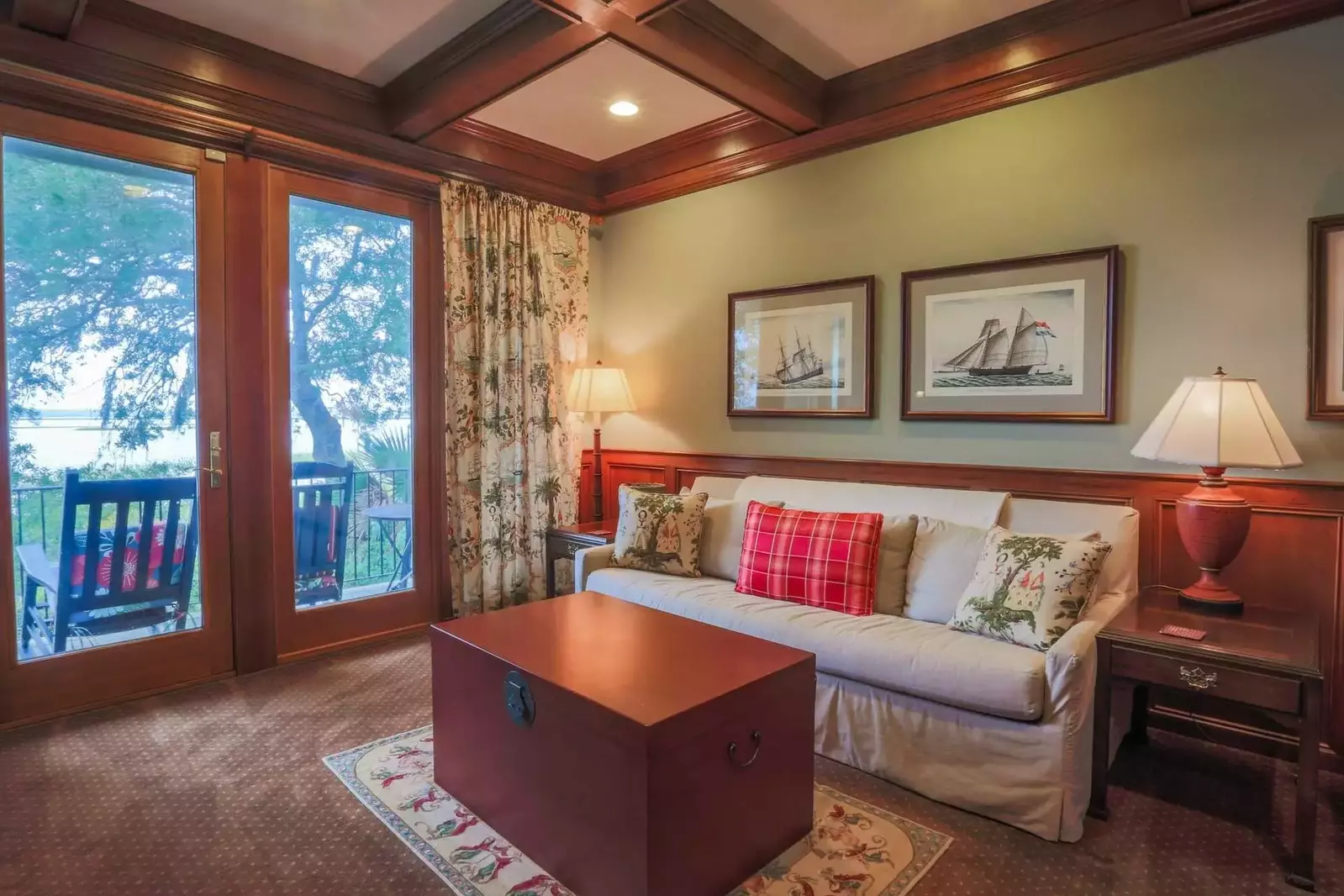 The den, which features a queen size sleeper sofa and access to the deck, is located on the ground floor.