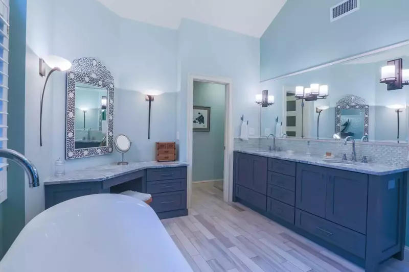 The master bathroom has a double vanity, soaking tub, dressing table and walk-in shower.