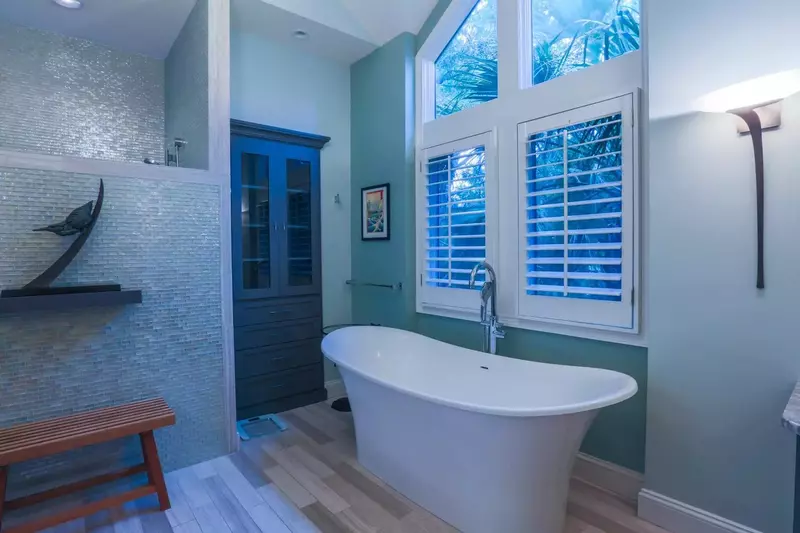 The master suite also features a separate walk-in shower behind the glass tiled wall & bench.