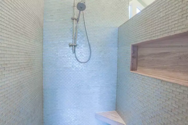 The beautiful glass tiles in the walk-in shower capture & reflect the light.
