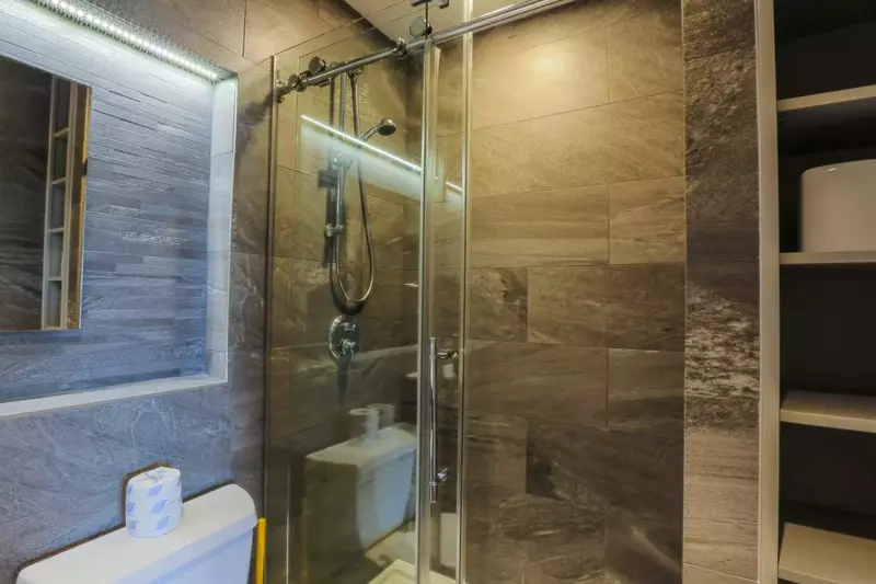 This en suite bathroom also has a tiled, walk-in shower.