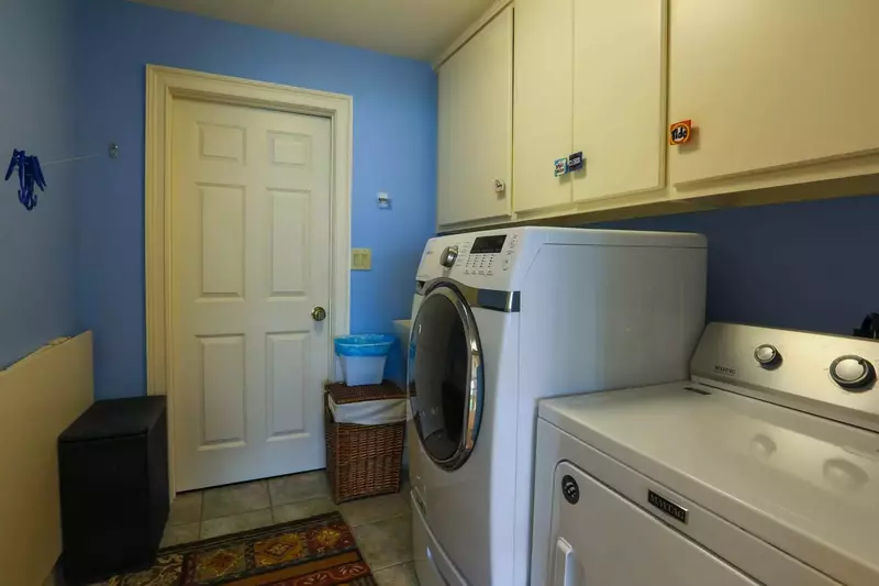 This laundry room with full sized washing machine and dryer are located on the home's second floor.