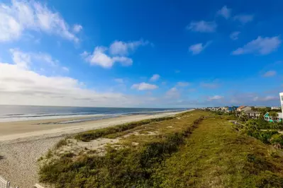 Sunshine Daydream overlooks the crashing Atlantic Ocean waves, sandy beach & gorgeous sand dunes.