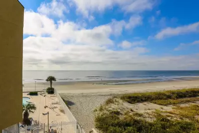 Sunshine Daydream is situated near the beach access point and one of the two oceanfront community pools.