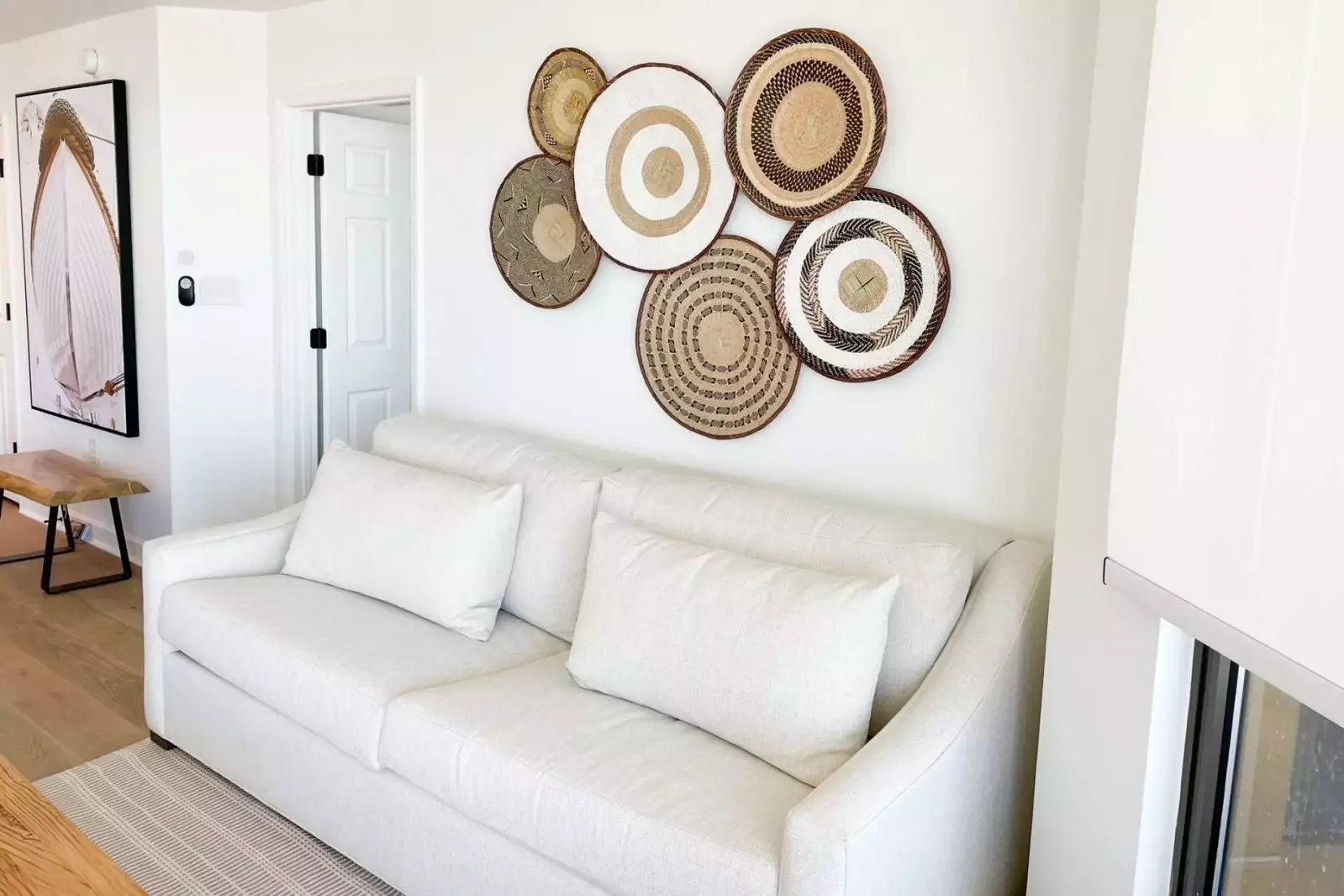 The master suite is located off of the living room through this door near the couch.