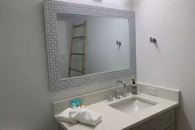 The en suite bathroom for the second master features a spacious vanity.