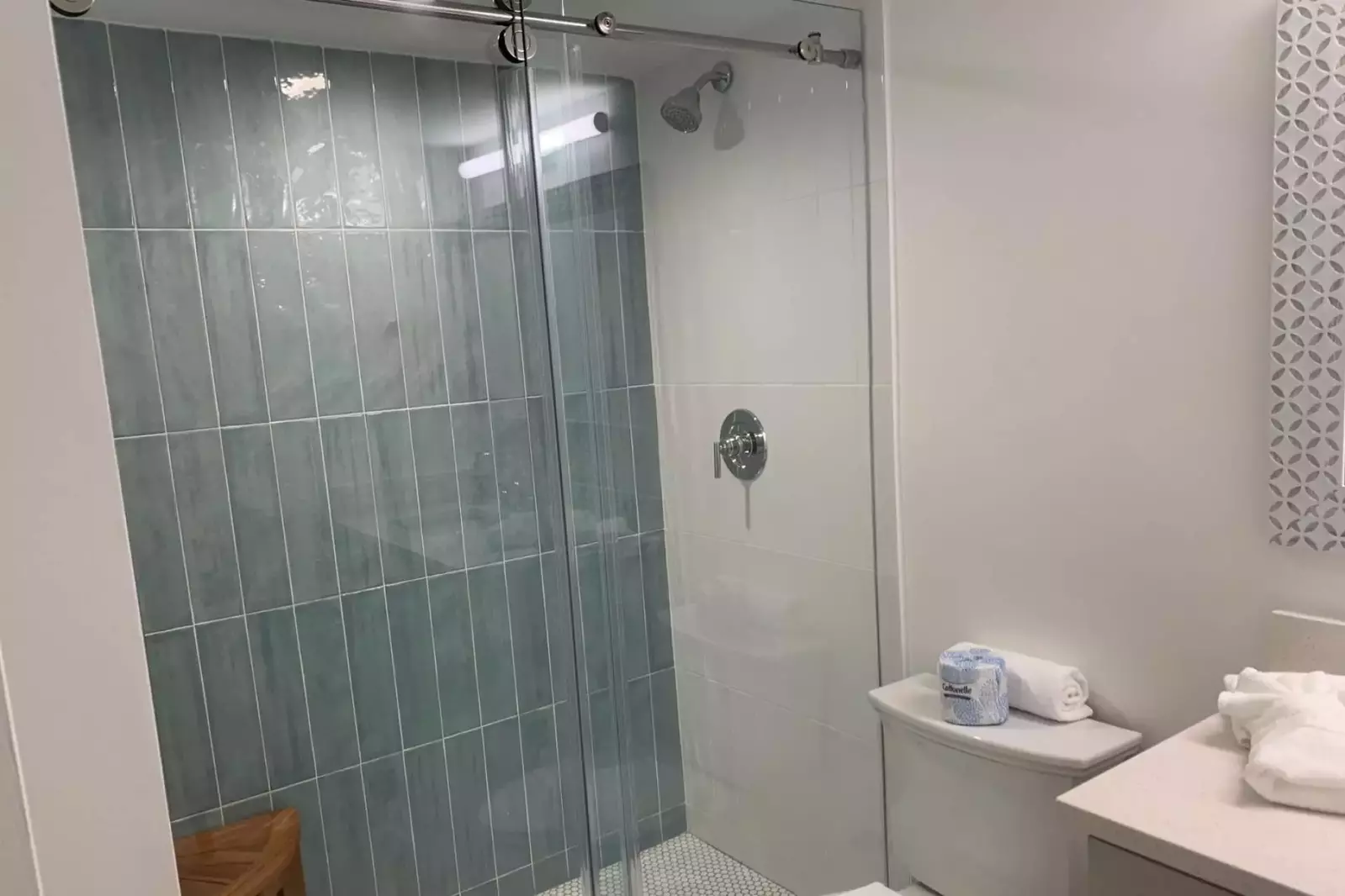 The en suite bathroom for the second master features a beautifully tiled walk-in shower.