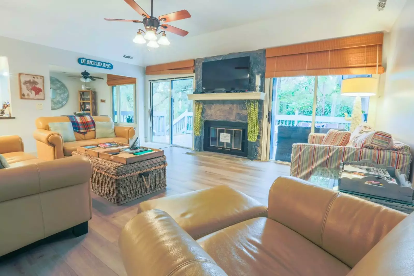 The home has a spacious, comfortable living room with two sets of sliding doors to the back porch.