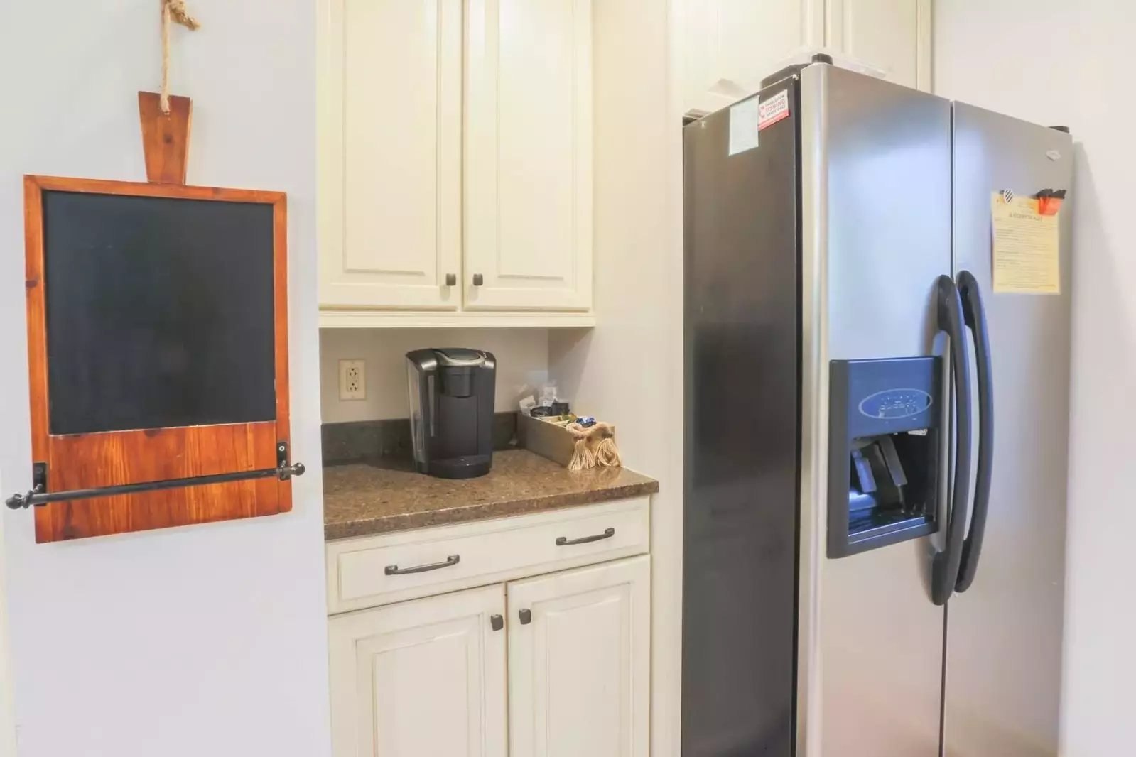 The kitchen has a keurig coffee maker, refrigerator, range, dishwasher & microwave.