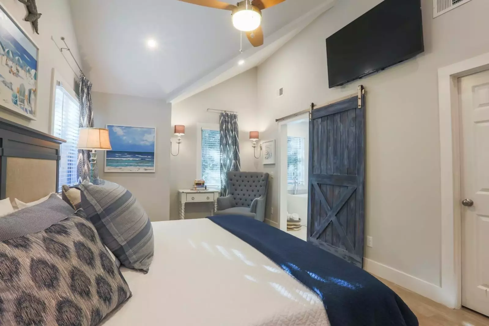 There is also a mounted, large screen TV, ceiling fan and en suite bathroom.