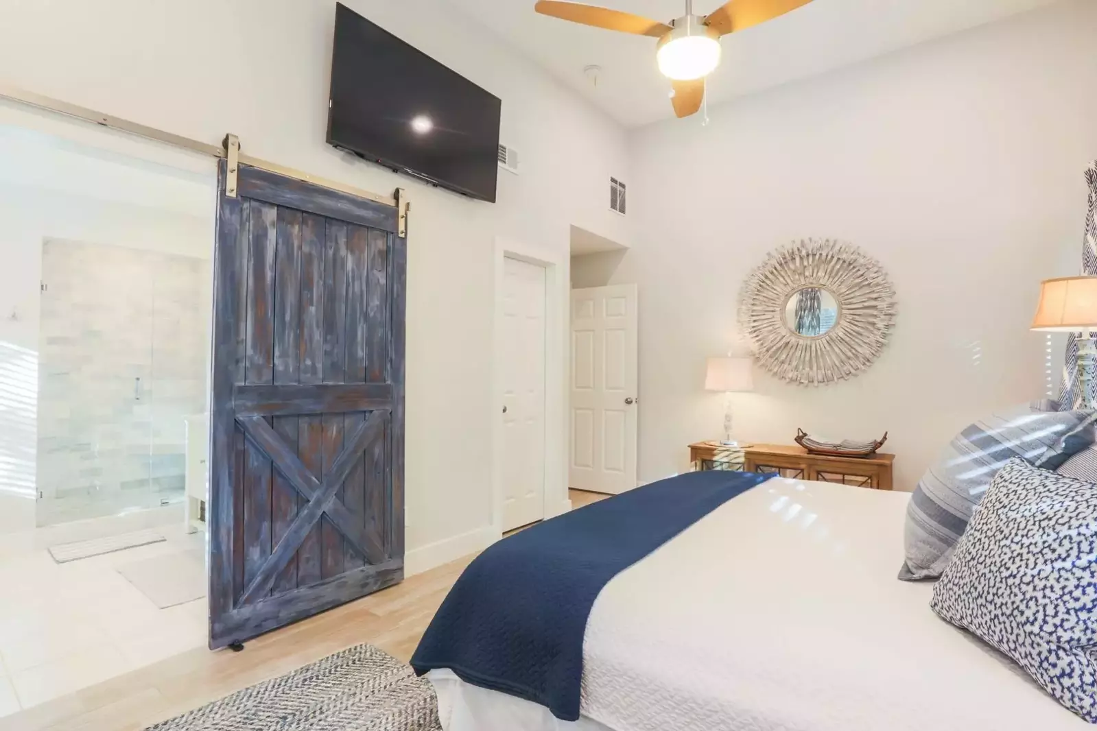 The en suite bathroom has a sliding barn door.
