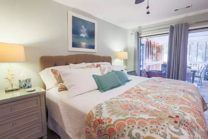 The home's second master suite has sliding door access to the screened porch.