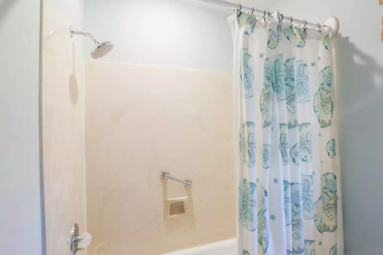 The en suite bathroom also has a shower/tub combo with a rain showerhead fixture.