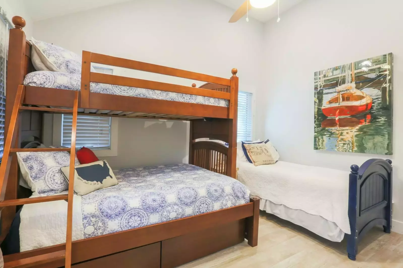 This guest bedroom features a bunk bed with full & twin beds.  There is also an additional twin bed.