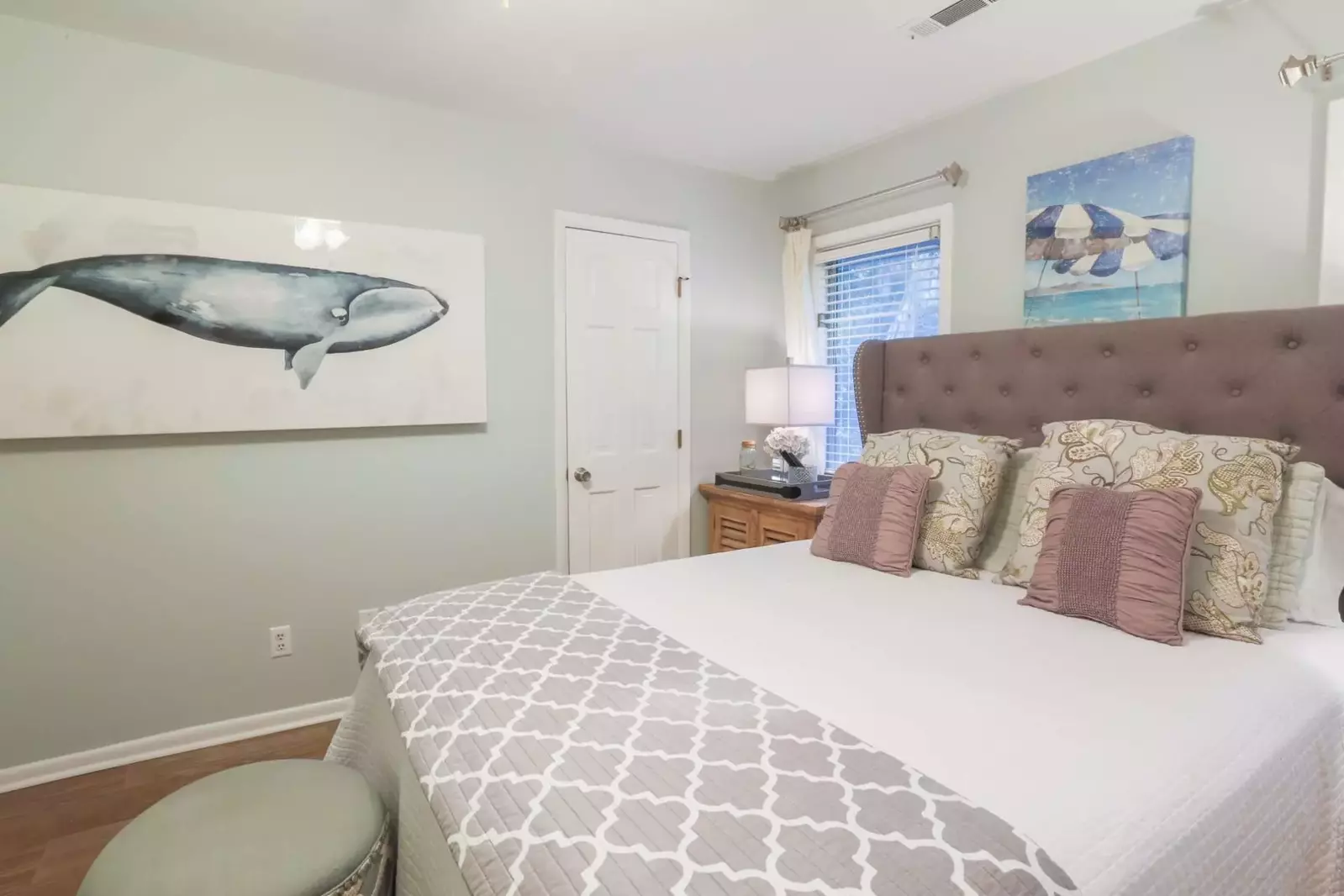 This guest bedroom has its own en suite half bathroom.