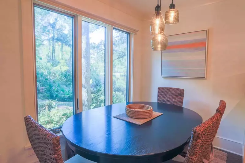 The dining table comfortably seats 6 people with 4 chairs and a bench.