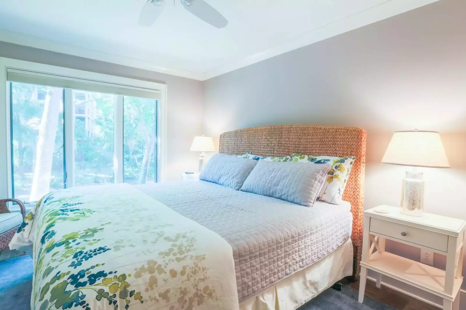The master bedroom features a king bed, nightstands with reading lamps and ceiling fan.