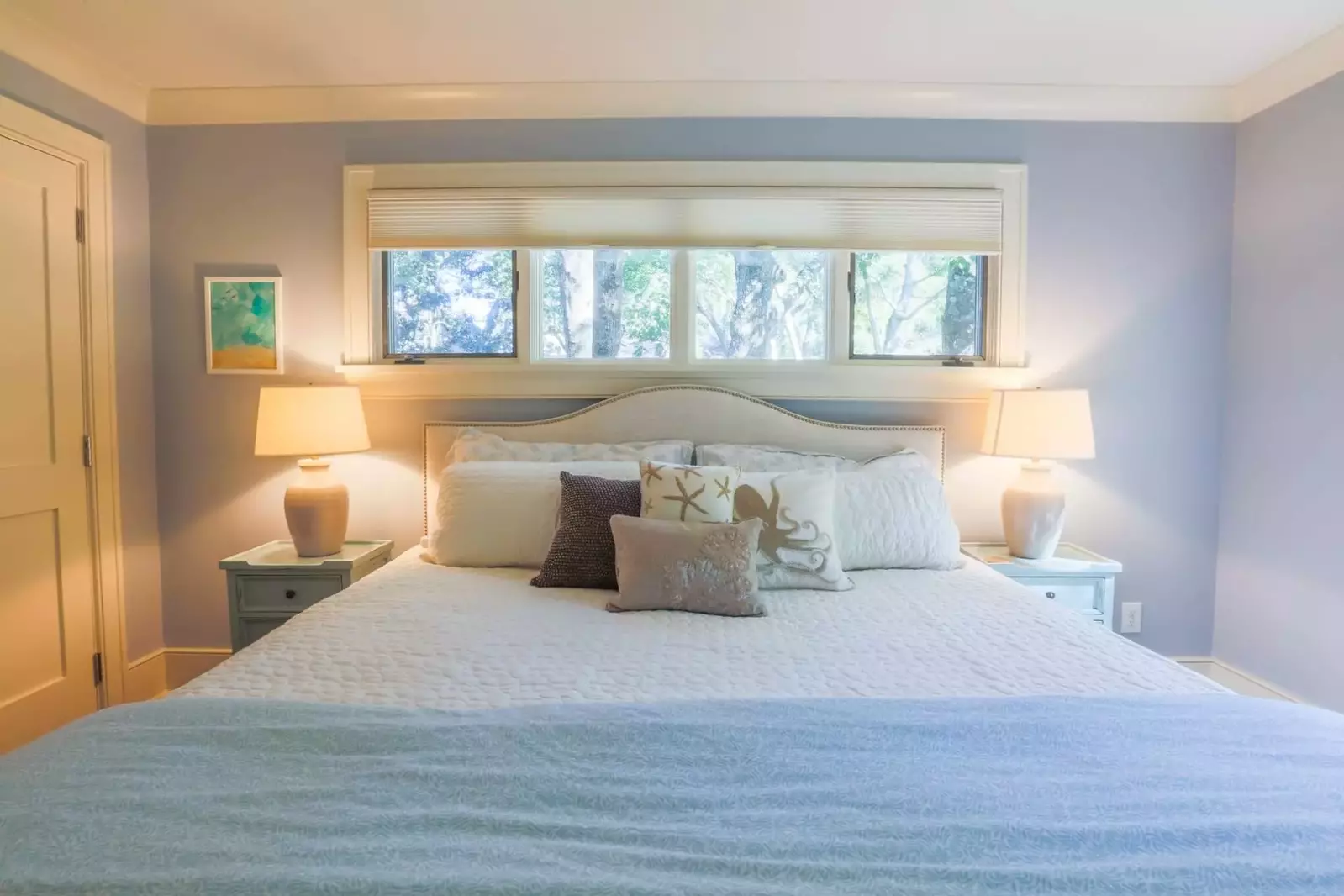 This guest bedroom suite features a king bed flanked by two nighstands with reading lamps.