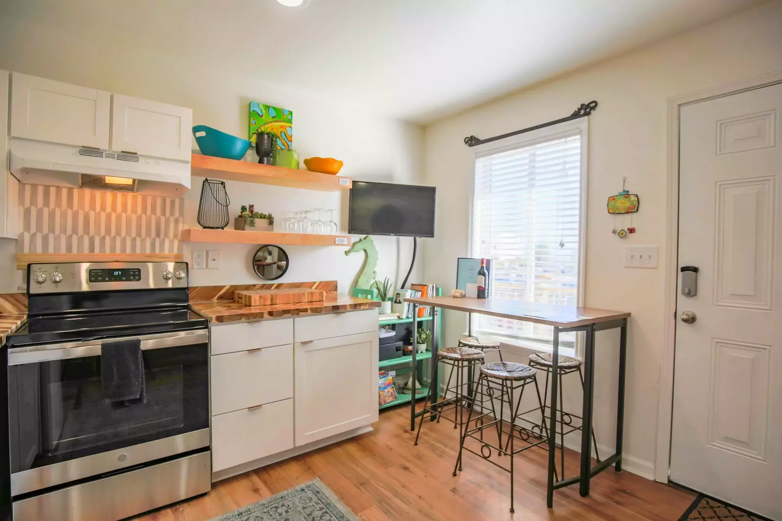 Shangri-La features a renovated kitchen with floating shelves and butcher block counters.
