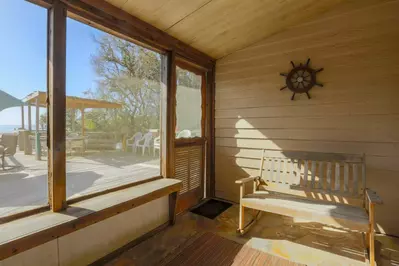Read a book and feel the cool seabreezes in our screened-in porch.