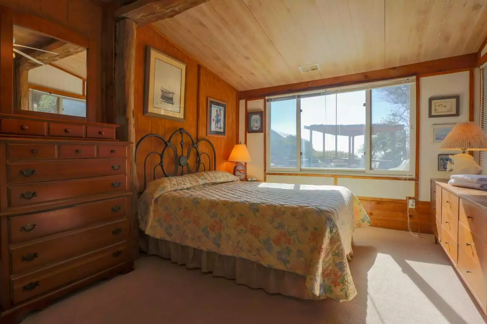 The master bedroom at Someplace Else overlooks the backyard deck and ocean.