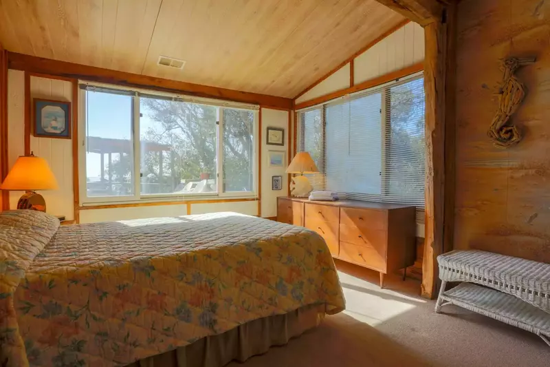 The master bedroom also features a queen-sized bed, dressers, night stand & reading lamps.