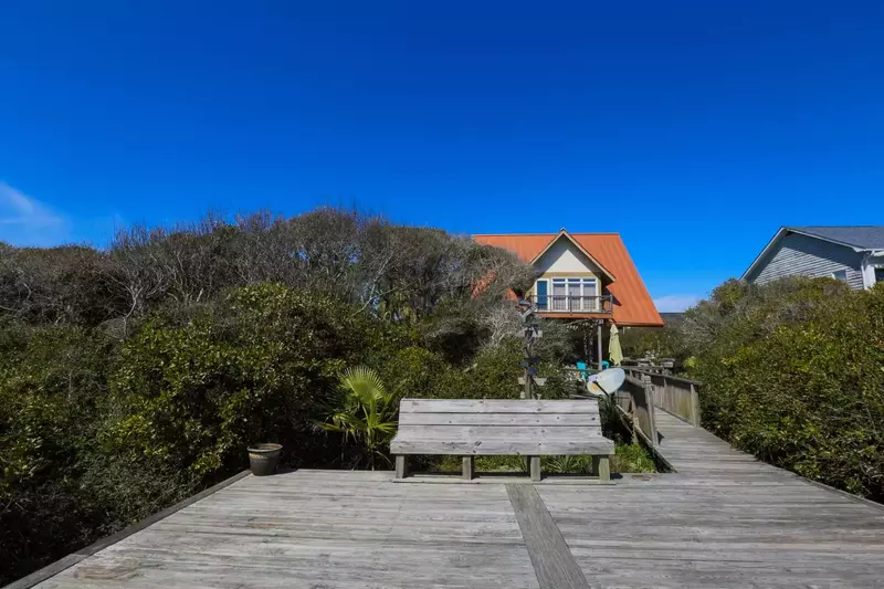 View of Someplace Else and its backyard deck from the boardwalk.